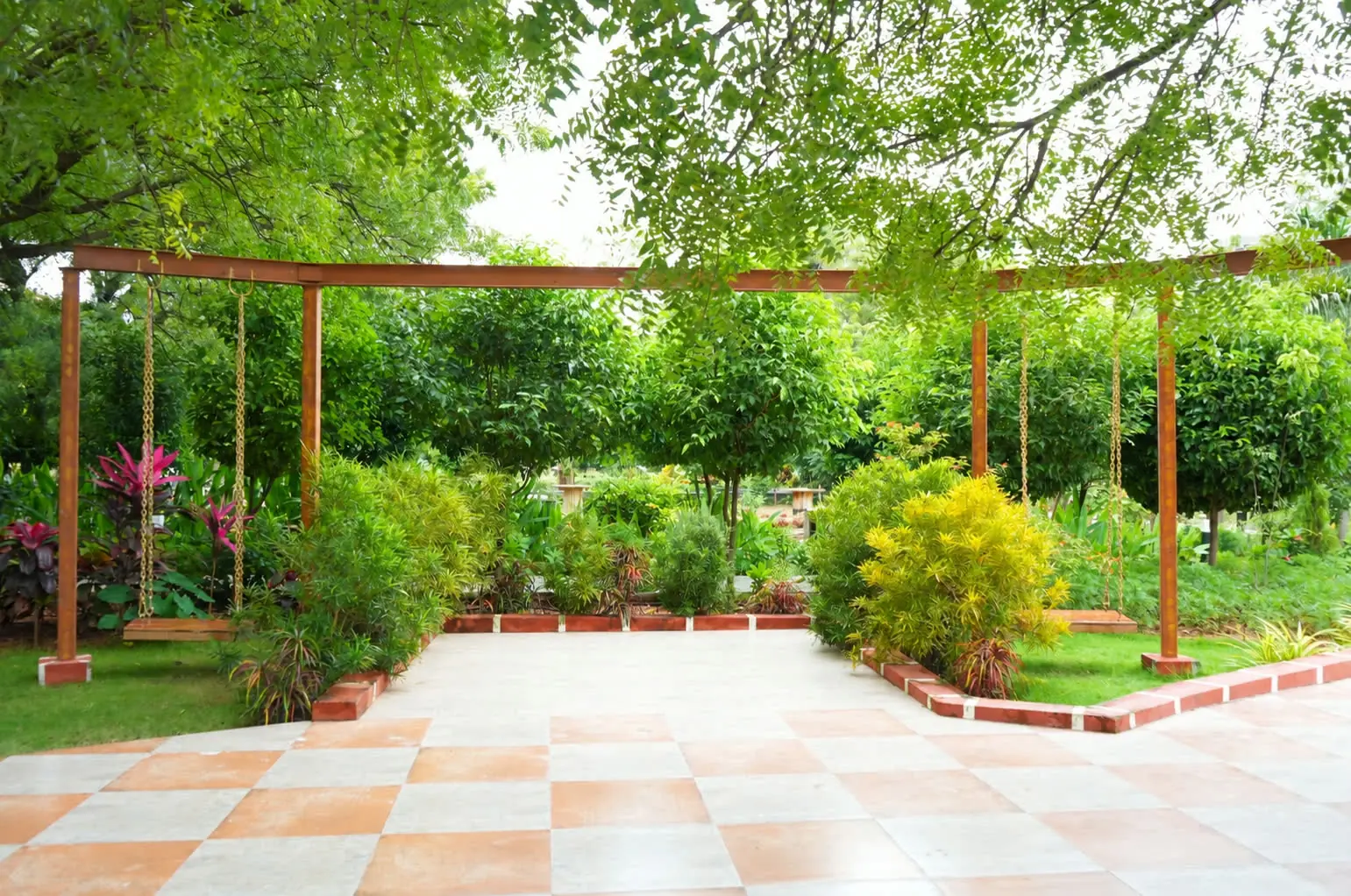 A swing pergola over a tiled pavilion in the gardens