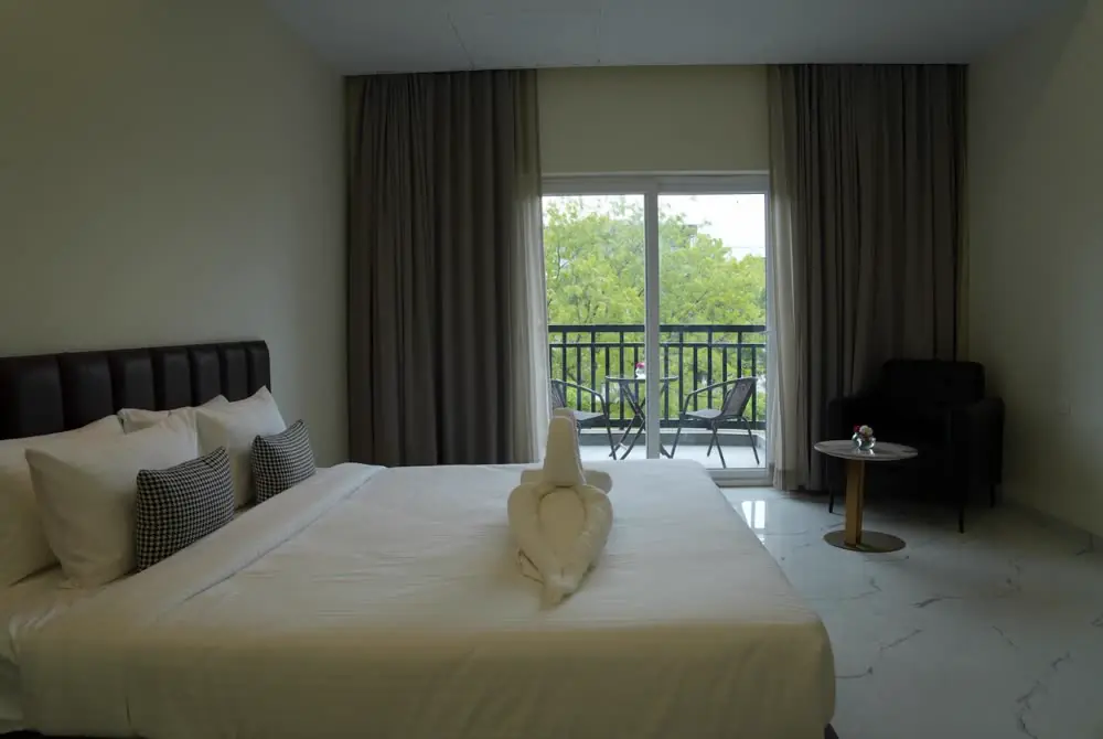 A guest room opening onto a balcony over the estate