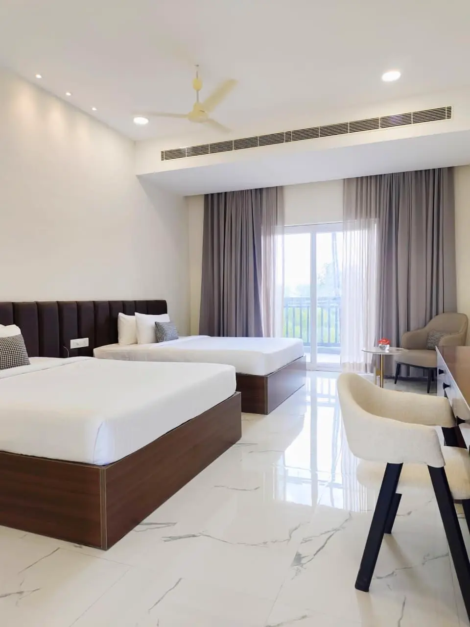 A twin-bed guest room with a marble floor