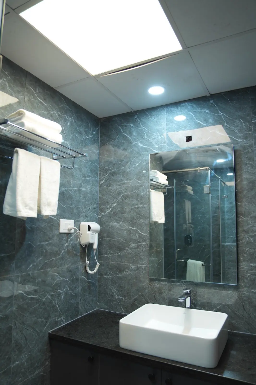 A modern vanity with a large mirror