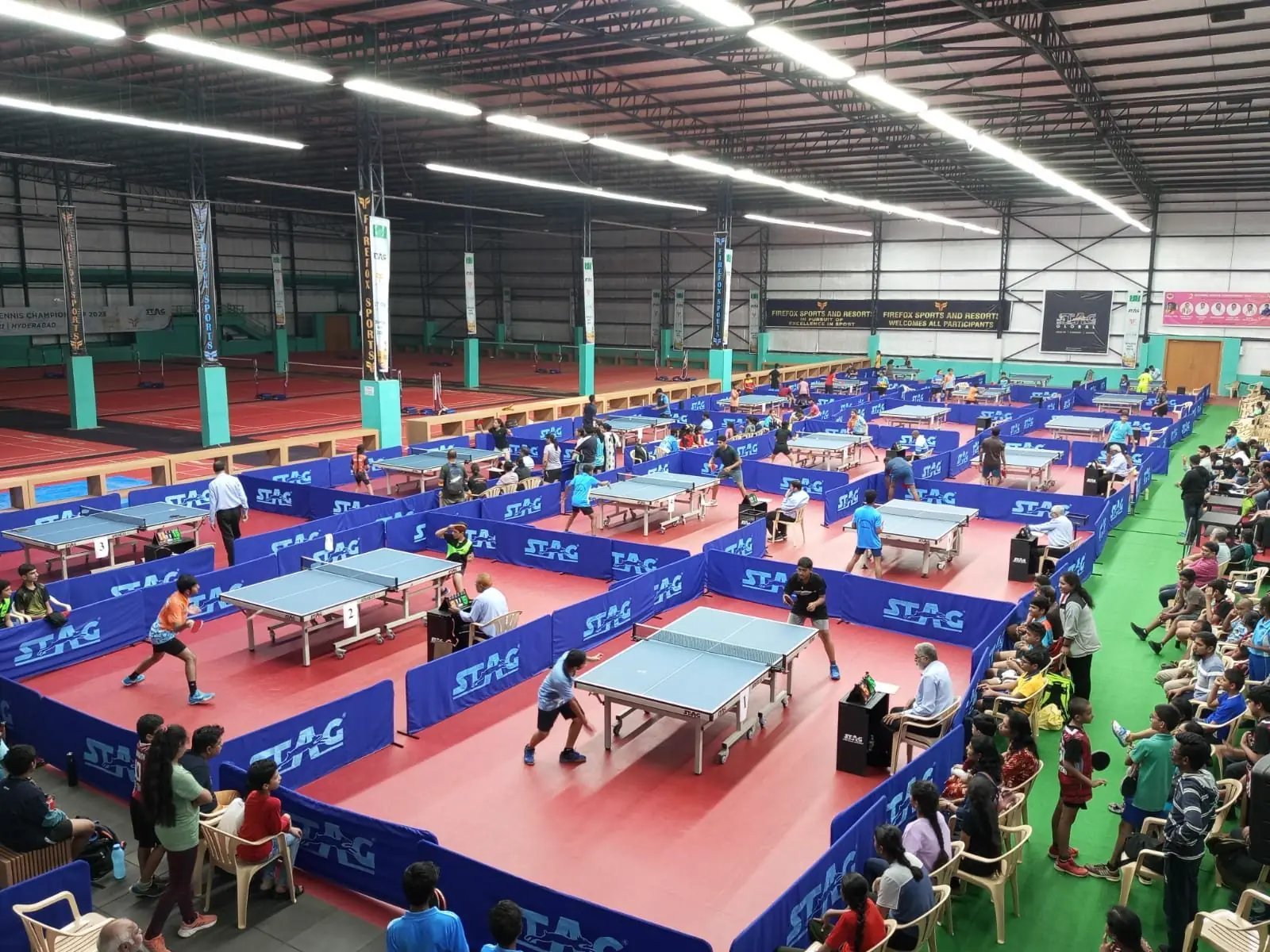 A table-tennis tournament across the tables of the indoor hall