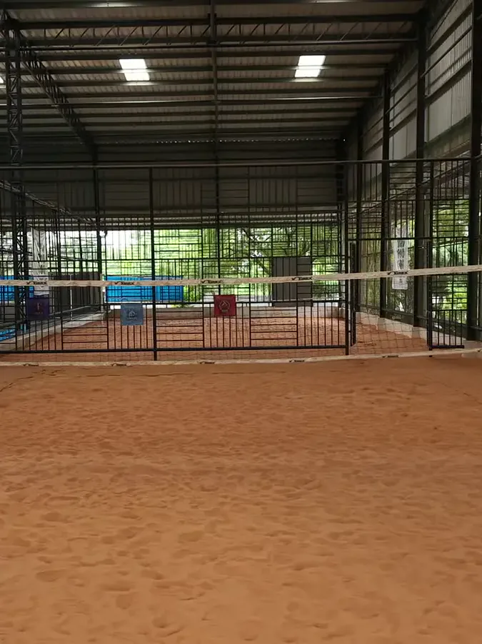 An indoor beach-volleyball sand court with its net