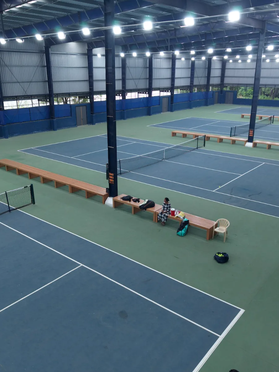 The indoor tennis courts seen from above under the lights