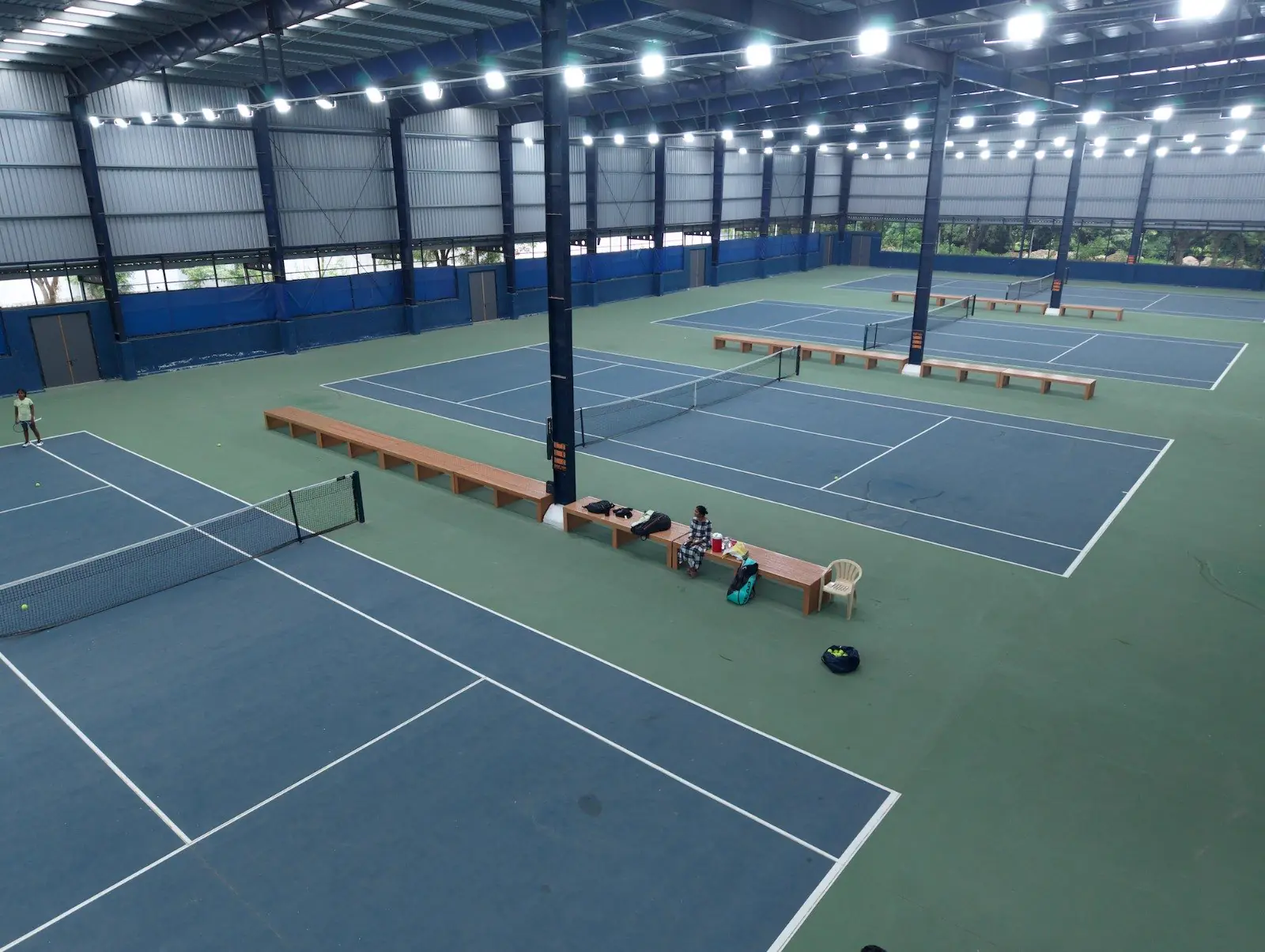 Indoor tennis courts under the lights, seen from above