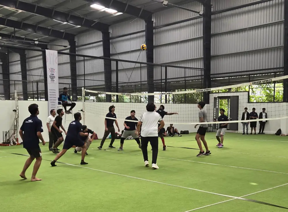 A volleyball match in play on the indoor turf
