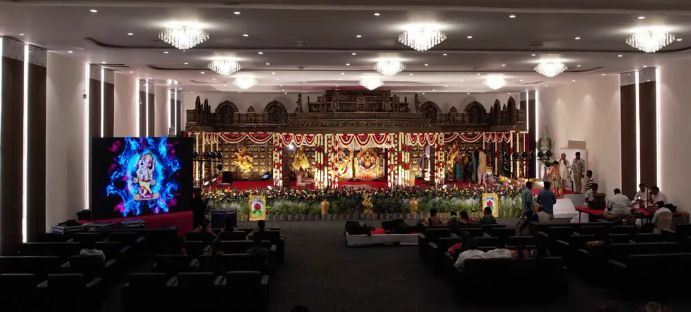 Gold mandap on an LED-lit stage
