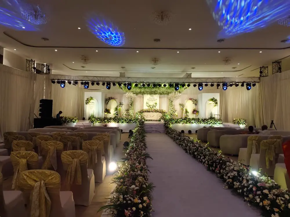 A floral aisle leading to the mandap inside the main hall